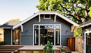 gray bungalow with glass Craftsman-style doors