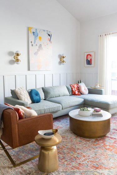colorful living room with sectional sofa and round coffee table