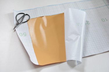 plastic backing on contact paper being removed