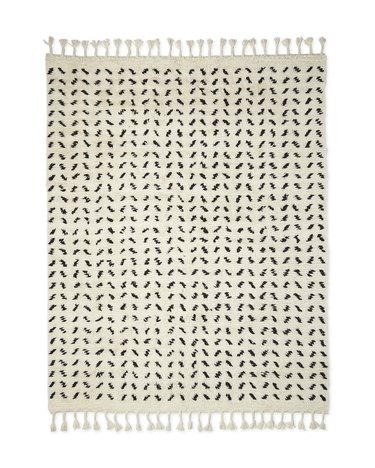 Black and white Scandinavian rug with tassels and graphic designs