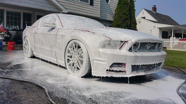 Soaping a car before washing.