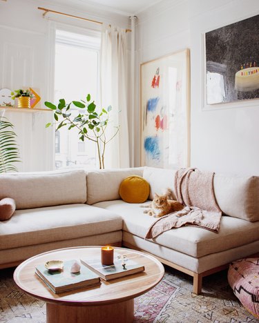 minimal white Scandinavian boho living room with taupe and wood sofa