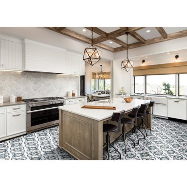 Vinyl patterned tile flooring in contemporary kitchen with white cabinetry and island with black barstools