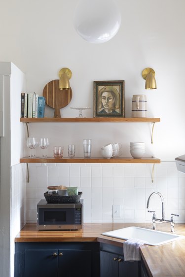 view of kitchen with butcherblock countertops and microwave