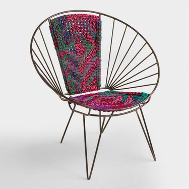Metal chair with a woven patterned center for bohemian living room