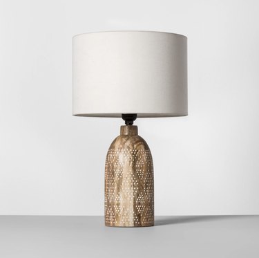 Table lamp with carved base for bohemian living room