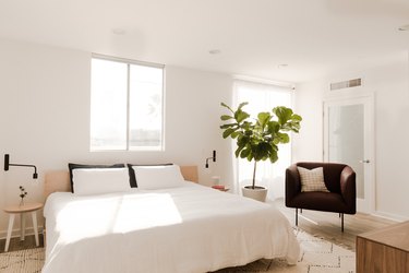 king size bed with white sheets in white bedroom