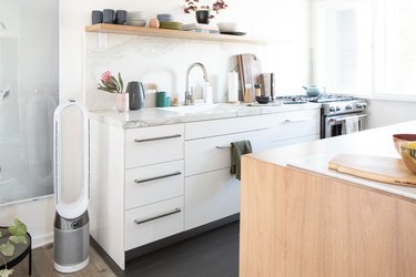 kitchen cabinetry with white stone countertop and backsplash