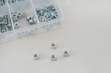 Box of assorted metal bolts and nuts.