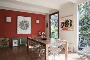 red dining room color idea with floor to ceiling windows and wood table