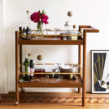 midcentury style bar cart with casters and brass detailing