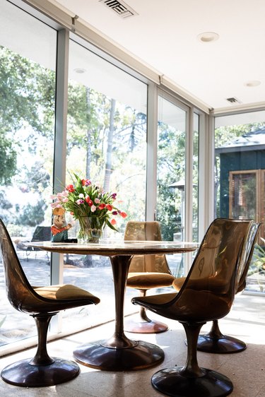 round dining table against floor-to-ceiling windows