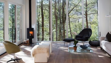 contemporary living room with big windows and wood stove fireplace