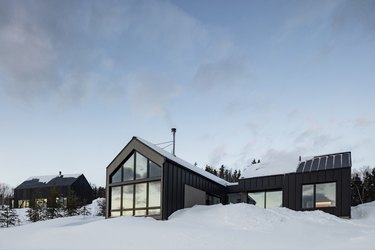 Scandinavian style house with large windows in snowy landscape