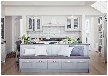 gray kitchen island with bench seating and built-in storage