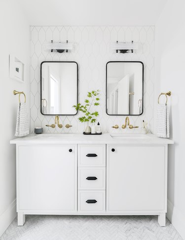 White Bathroom Cabinet with black hardware and double sinks by Emily Henderson Design