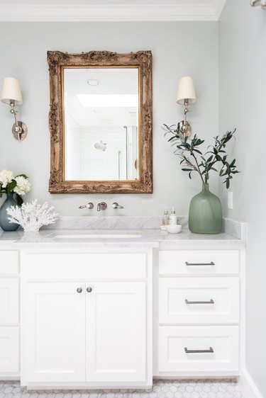 White bathroom cabinet with undermount sink and wall mount faucet by Christine Zeiler Interiors