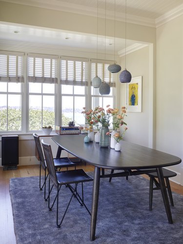 Dining room with ceramic pendant lighting, Swedish dining set, and wall of windows