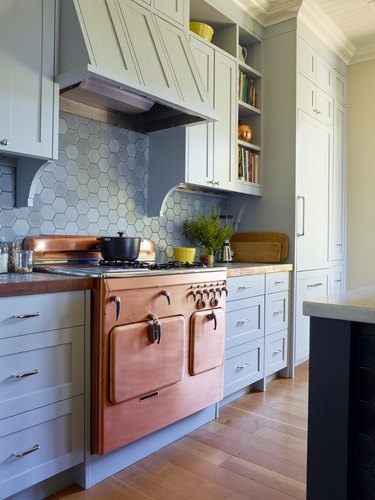 1950 Chambers copper stove with chrome details in powder blue kitchen with hexagon backsplash