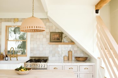 kitchen with pale wood accents, rustic tile and white quartz countertop