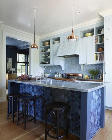 Contemporary kitchen with different shades of blue hexagon heath tile and kitchen island