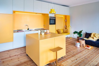 open concept yellow living room and kitchen