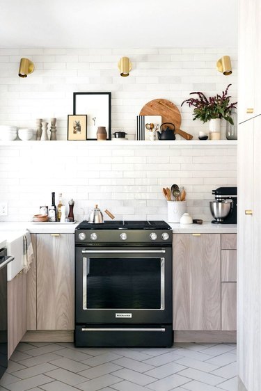 white and black kitchen cabinet hardware idea with brass hardware and white subway tile backsplash