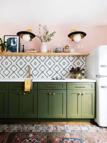 pink and green kitchen with white backsplash