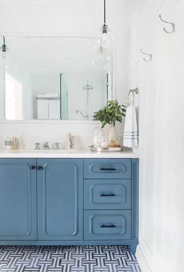 pigeon blue bathroom cabinets in coastal bathroom with white countertop and patterned tile