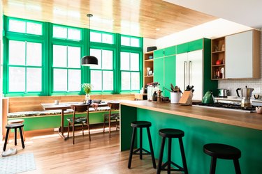 green kitchen with wood flooring and countertop