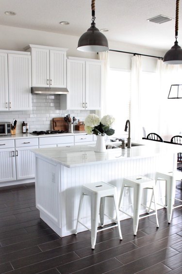 white beadboard kitchen island and white countertop