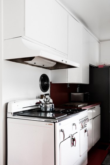 oven with range hood and white cabinets