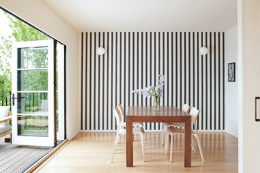 dining room with striped wallpaper