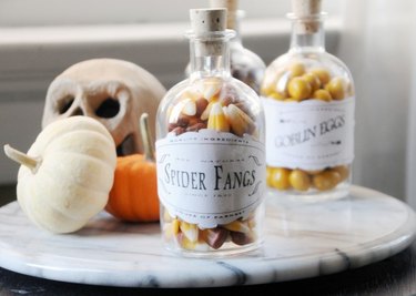 glass jars filled with candy and Halloween inspired labels
