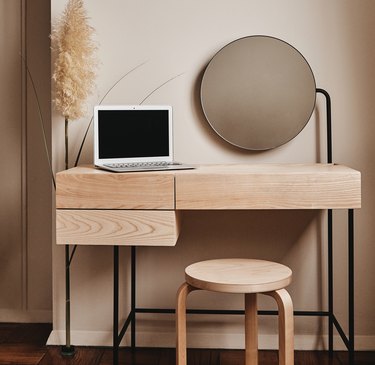 table with computer, mirror and stool nearby