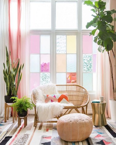 living room with pink drapery panels and pink stained glass windows