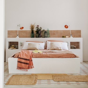 vases full of dried foliage lined up on a headboard