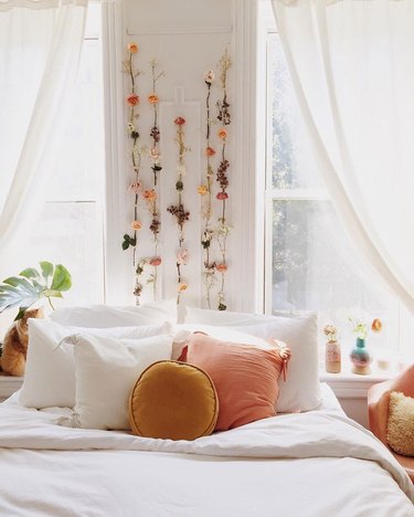 bedroom with dried flowers hanging above the bed