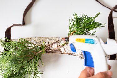 Glueing greenery with hot glue