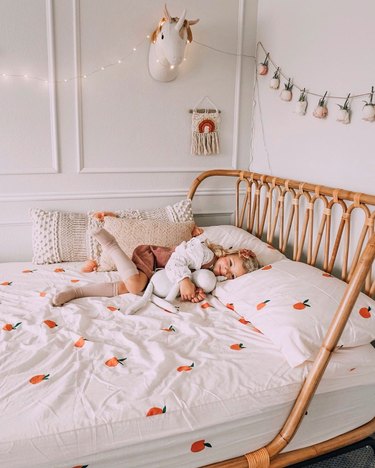 all-white Scandinavian kids bedroom idea with rattan bed