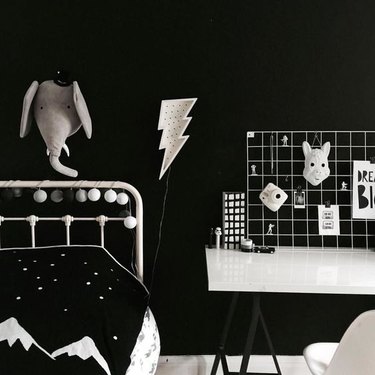 kids bedroom idea with graphic accessories and dramatic black walls