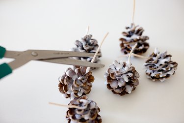 Cut excess wick off pine cones