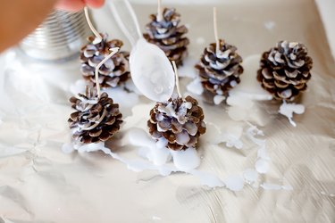 Dripping wax onto pine cones