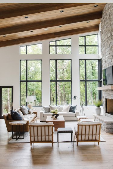 living room with a sloped ceiling and a wall of windows