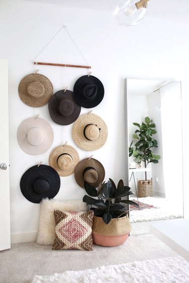 hats hung on wall with clothespins