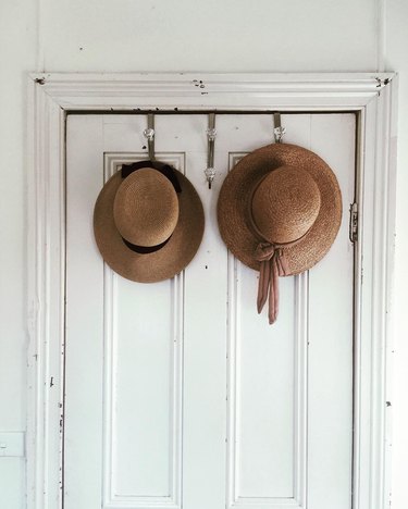 hats hung on the back of a door