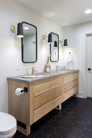 bathroom with concrete countertop and wood vanity