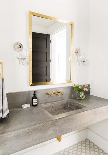 bathroom with concrete countertop and integrated sink