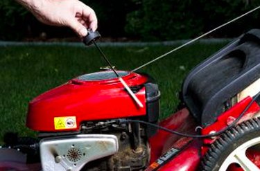 Checking the oil in a lawn mower.