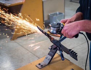 Sharpening a lawn mower blade.